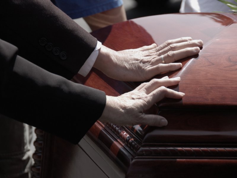 Hands on coffin - Boston wrongful death lawyer